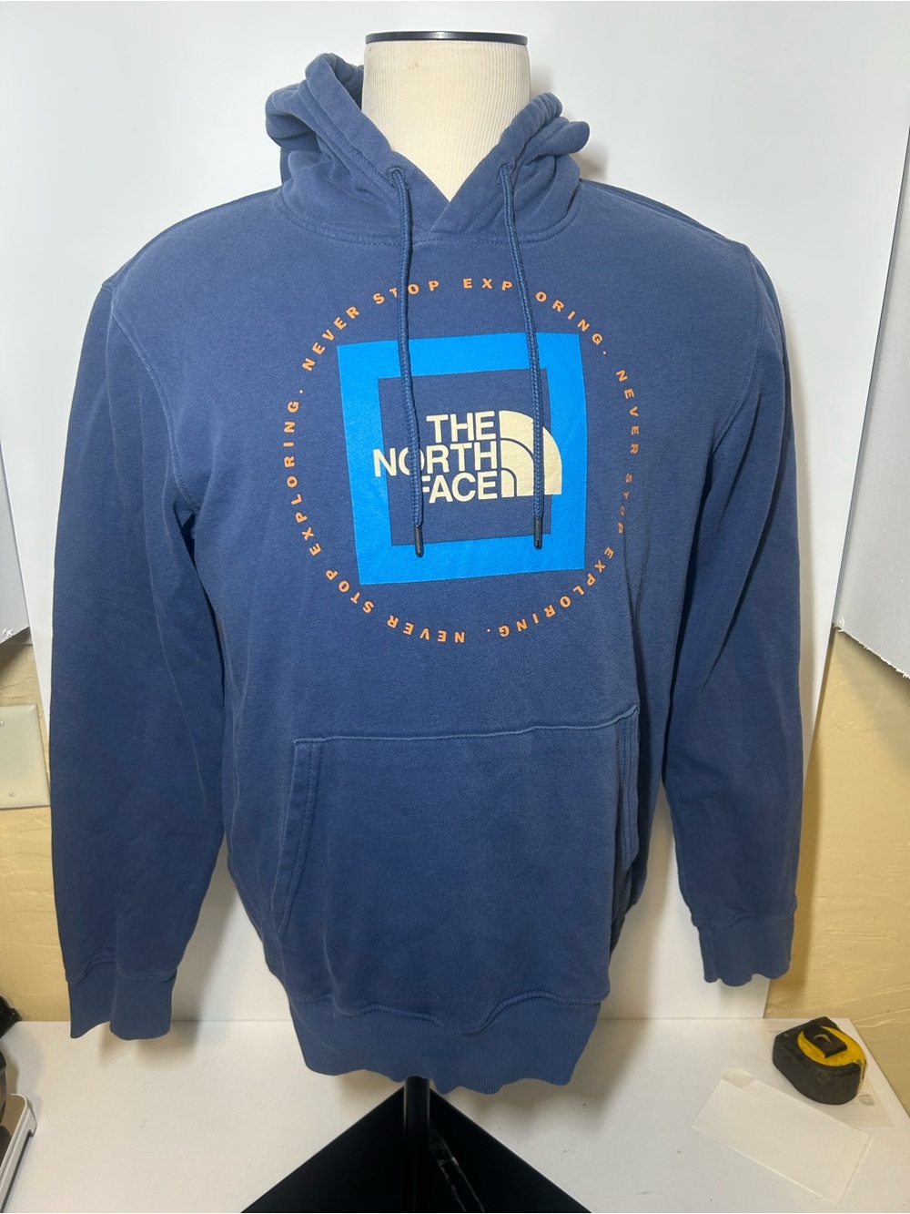 The North Face Men's Navy Pullover Hoodie with Blue Logo and Orange Accent